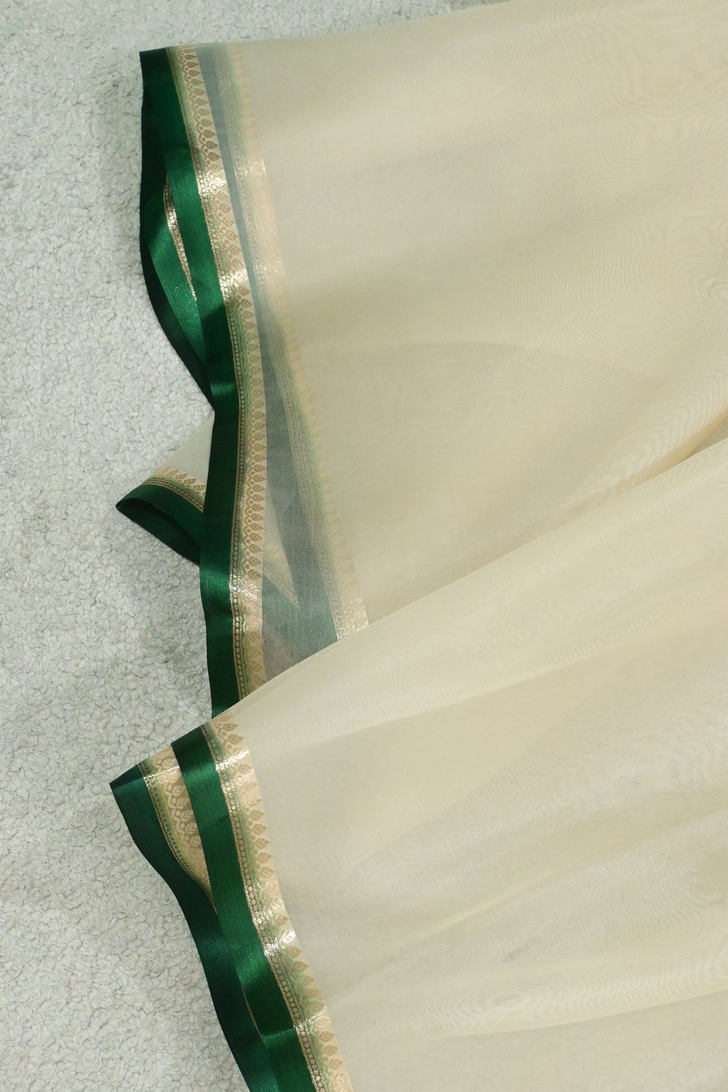 Handloom pure kora organza silk saree having satin bottlegreen selvage