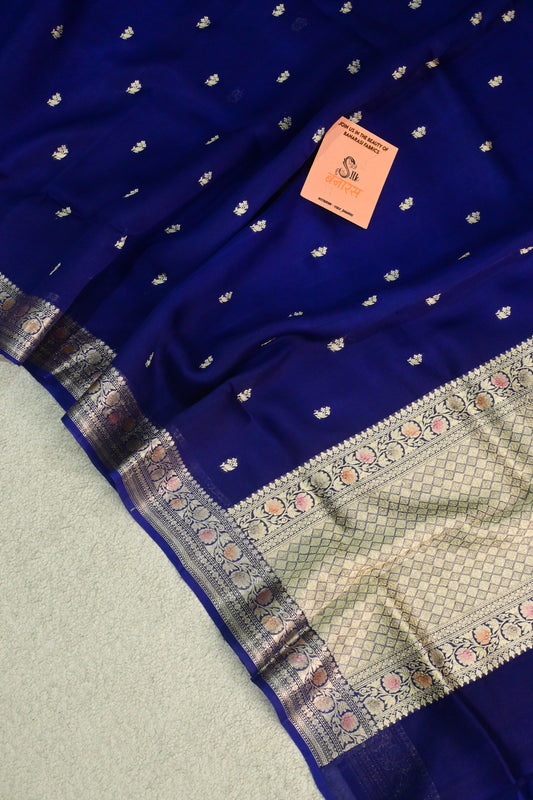 Royal blue organza saree with light gold zari weaving, handbrush work effortlessly gracefully