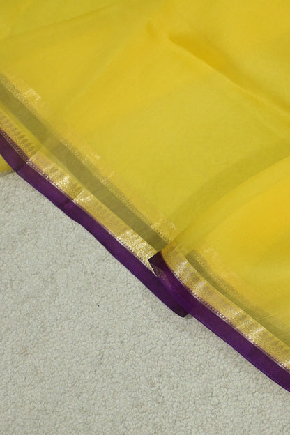 Handwoven pure Kora organza saree in contrast yellow with purple edge