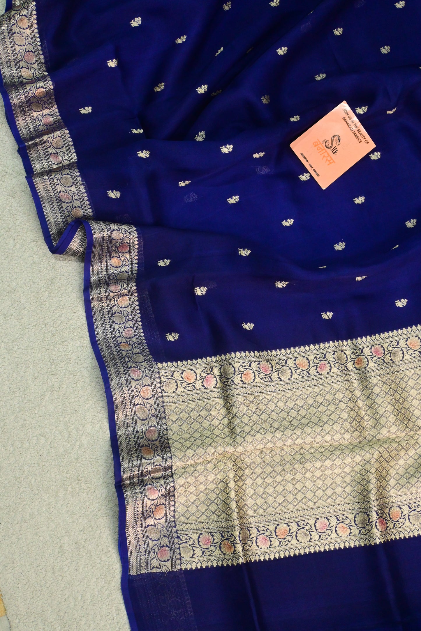 Royal blue organza saree with light gold zari weaving, handbrush work effortlessly gracefully