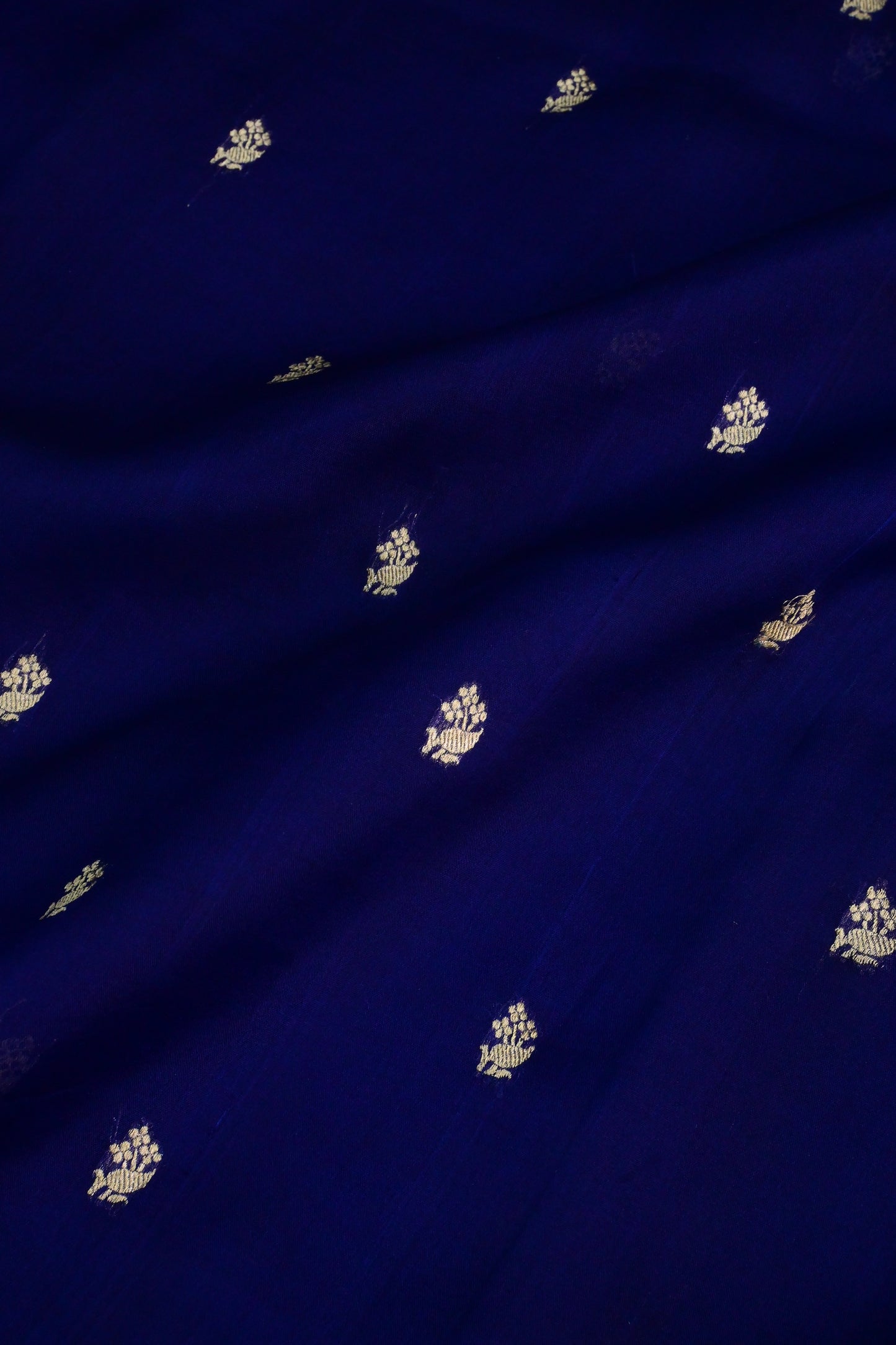Royal blue organza saree with light gold zari weaving, handbrush work effortlessly gracefully
