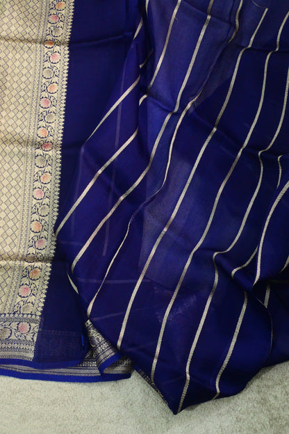 Royal blue organza saree with light gold zari weaving, handbrush work effortlessly gracefully