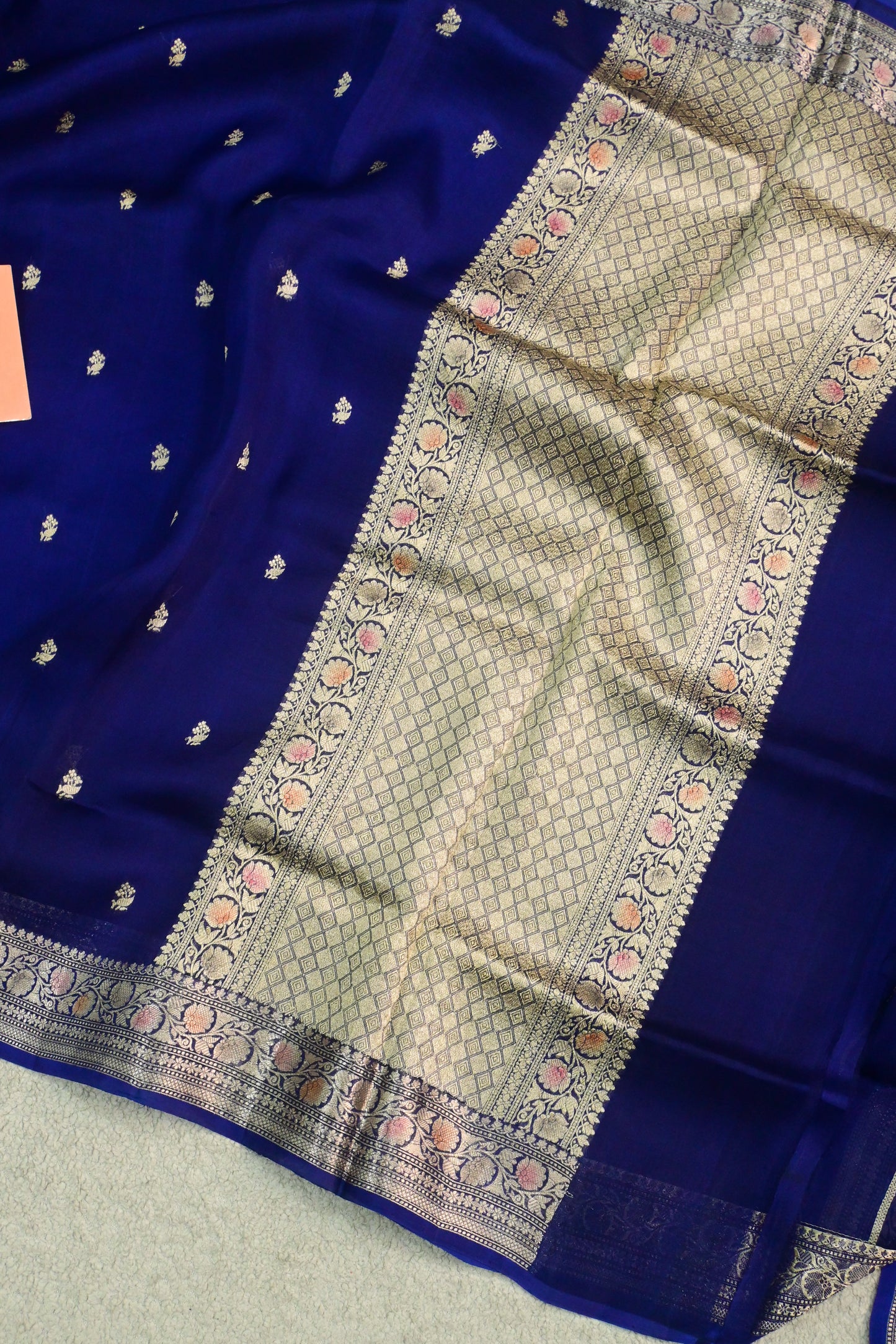 Royal blue organza saree with light gold zari weaving, handbrush work effortlessly gracefully