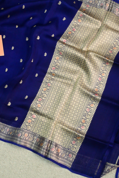 Royal blue organza saree with light gold zari weaving, handbrush work effortlessly gracefully