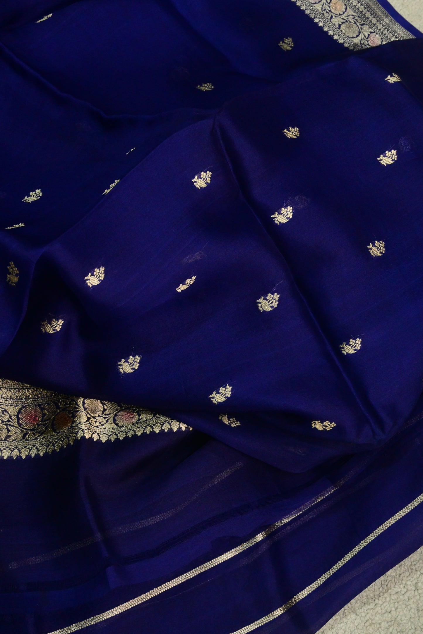 Royal blue organza saree with light gold zari weaving, handbrush work effortlessly gracefully