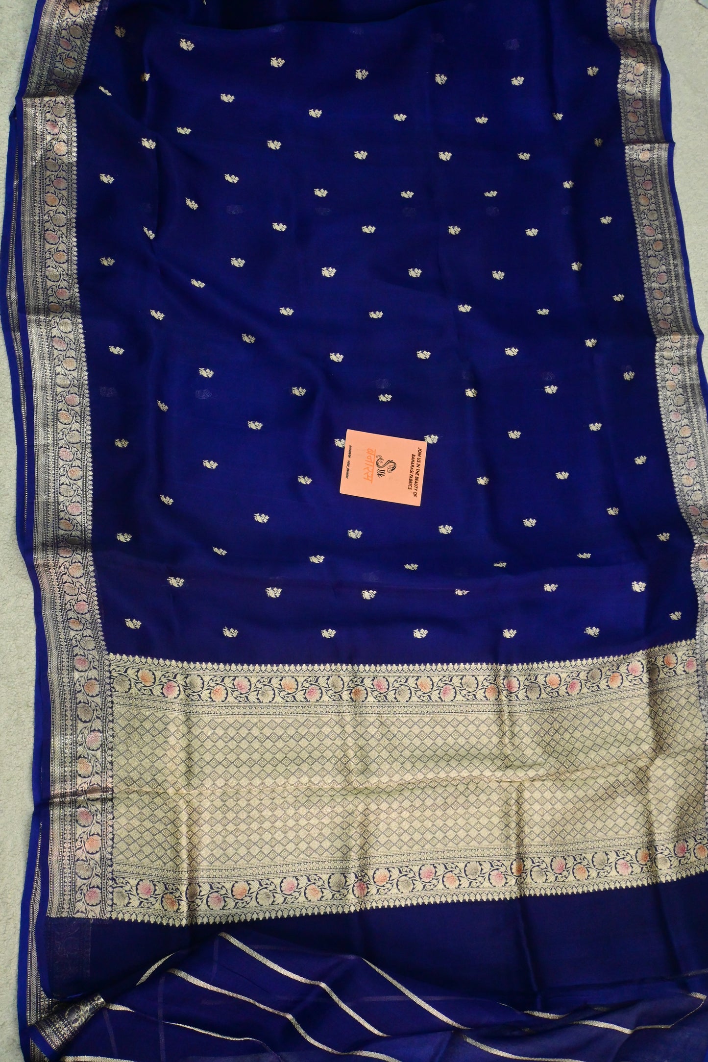 Royal blue organza saree with light gold zari weaving, handbrush work effortlessly gracefully