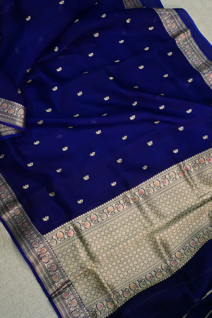 Royal blue organza saree with light gold zari weaving, handbrush work effortlessly gracefully