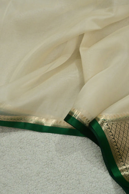 Handloom pure kora organza silk saree having satin bottlegreen selvage
