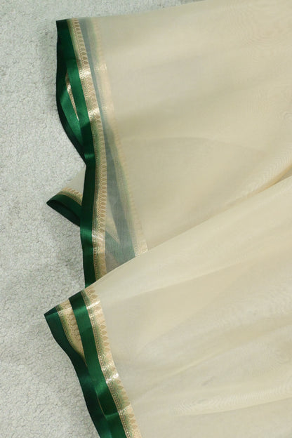 Handloom pure kora organza silk saree having satin bottlegreen selvage