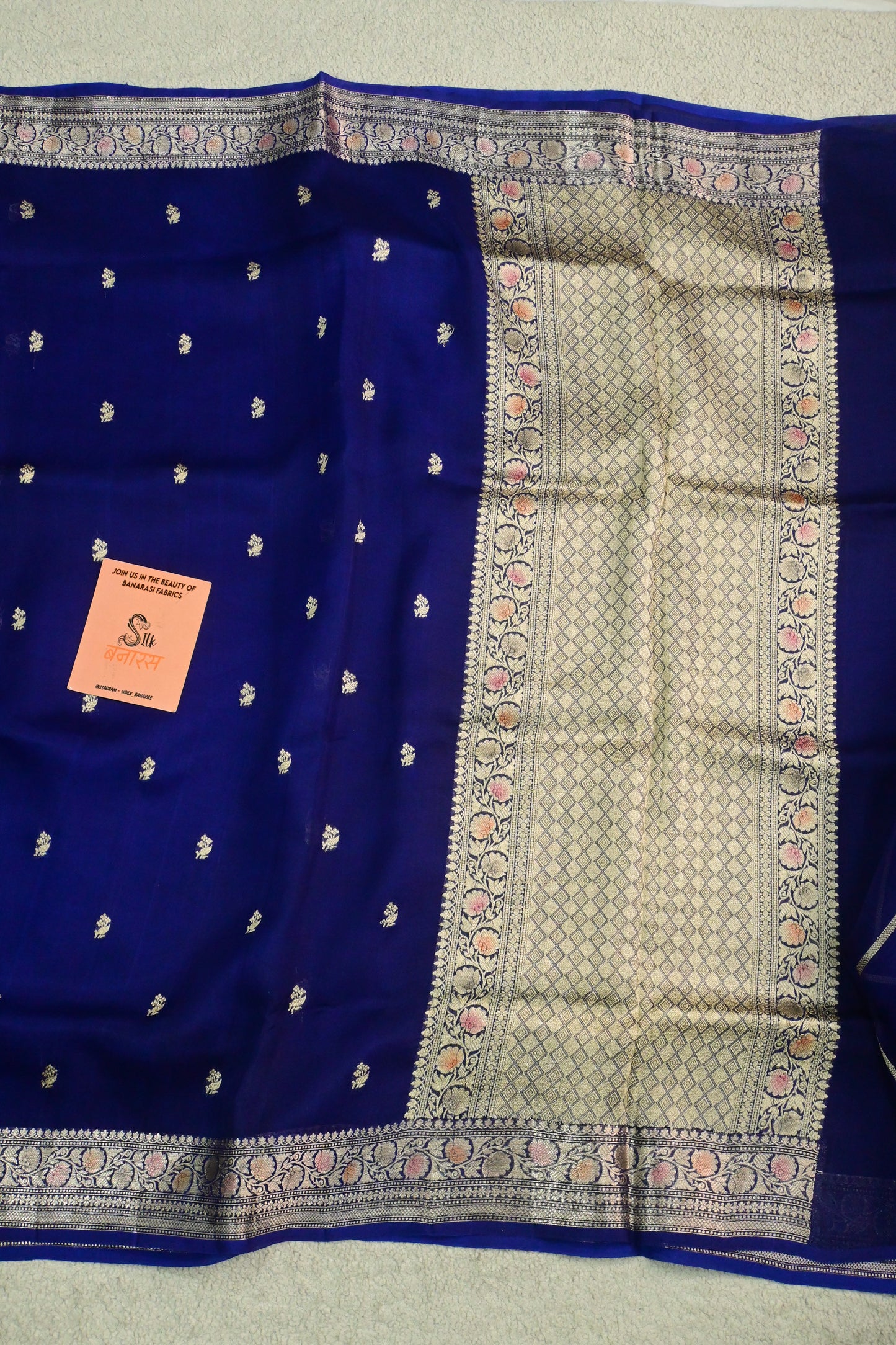Royal blue organza saree with light gold zari weaving, handbrush work effortlessly gracefully