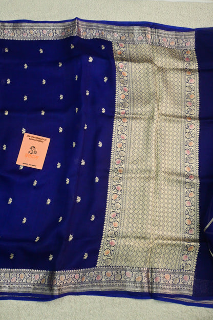 Royal blue organza saree with light gold zari weaving, handbrush work effortlessly gracefully